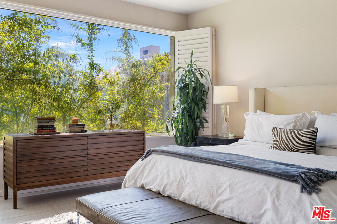 155 Desert W Drive Rancho Mirage, CA 92270 - Photo 30 of 50 a bedroom with a bed and a potted plant