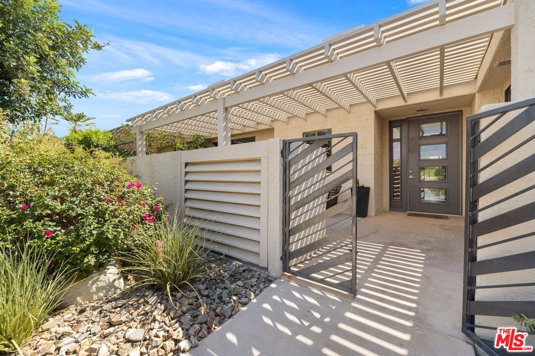 155 Desert W Drive Rancho Mirage, CA 92270 - Photo 3 of 50 a view of a porch with a door and plants