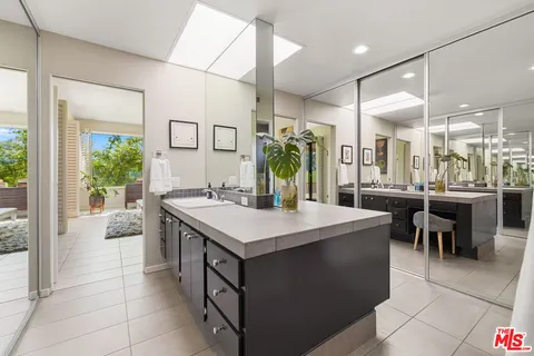 a bathroom with a sink double vanity and a mirror