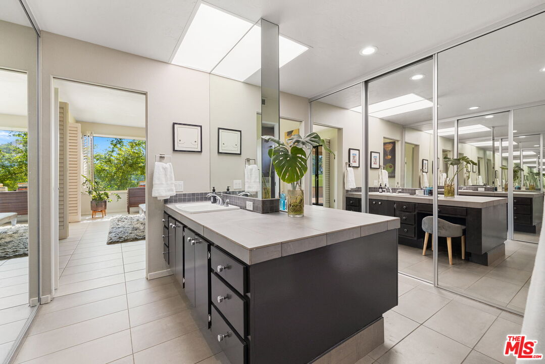 155 Desert W Drive Rancho Mirage, CA 92270 - Photo 31 of 50 a large kitchen with a table and chairs