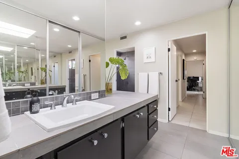 a bedroom with a bed a desk and chair