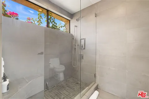 a bedroom with a large bed and a large window