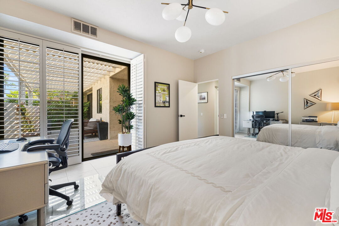 155 Desert W Drive Rancho Mirage, CA 92270 - Photo 36 of 50 a bedroom with a large bed and a large window