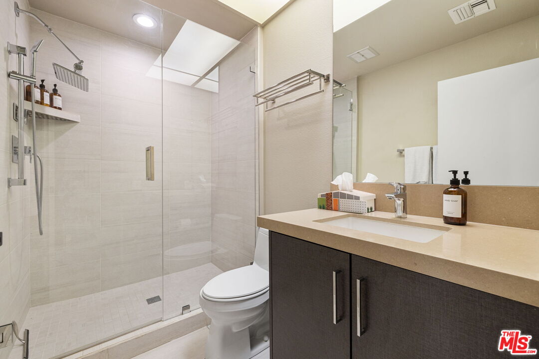 155 Desert W Drive Rancho Mirage, CA 92270 - Photo 37 of 50 a bathroom with a sink a toilet and shower