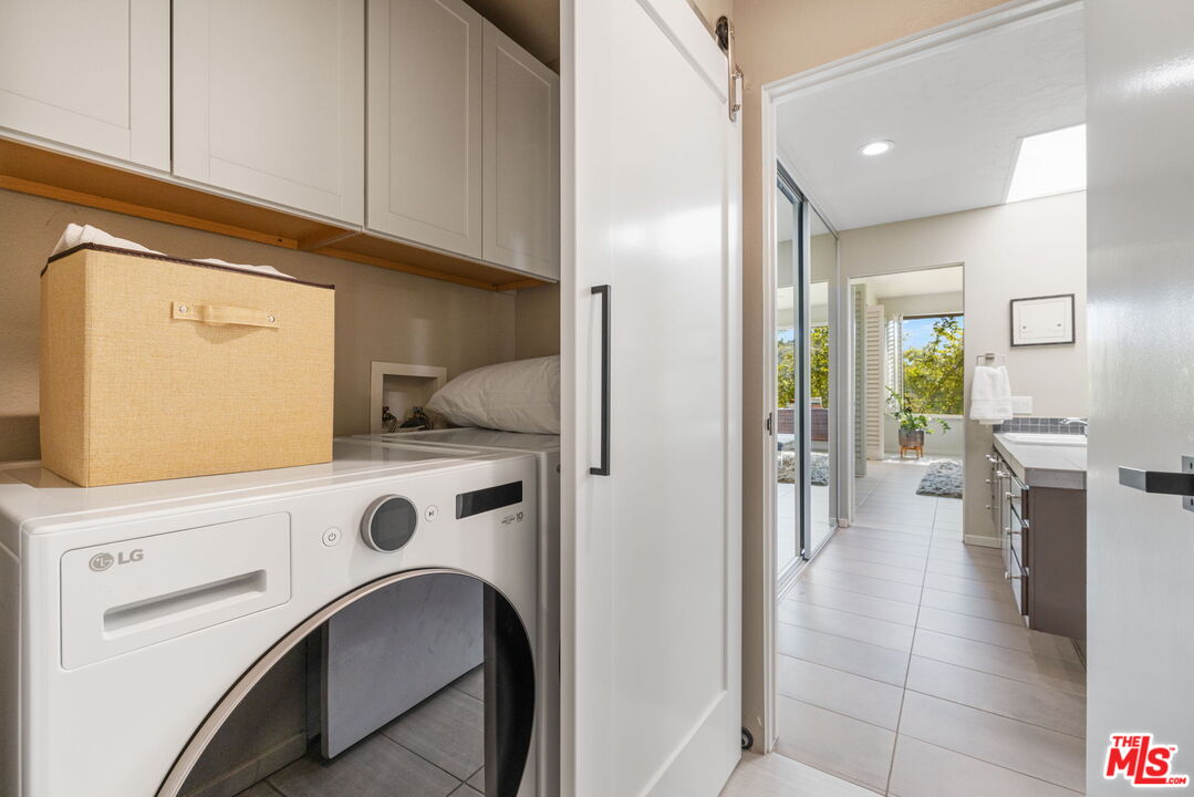 155 Desert W Drive Rancho Mirage, CA 92270 - Photo 38 of 50 a kitchen with a refrigerator and cabinets