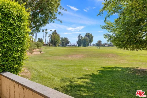a living room with furniture and large windows