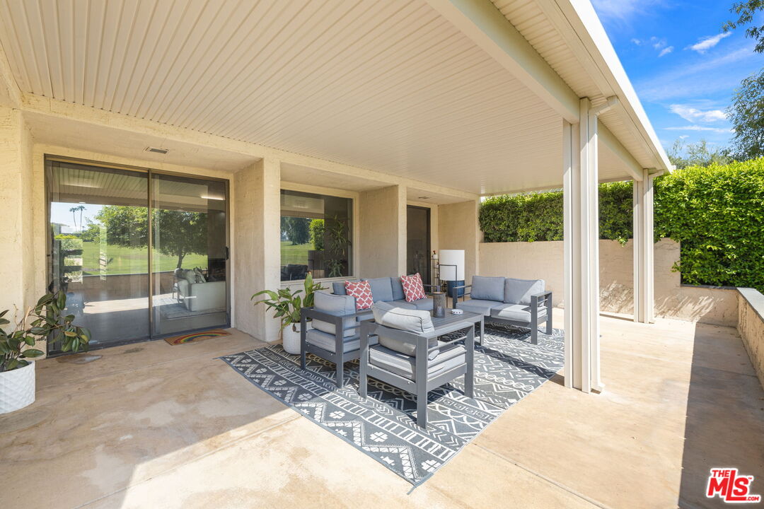 155 Desert W Drive Rancho Mirage, CA 92270 - Photo 43 of 50 a living room with furniture and large windows