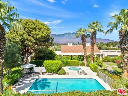 a view of a lush green hillside and a houses