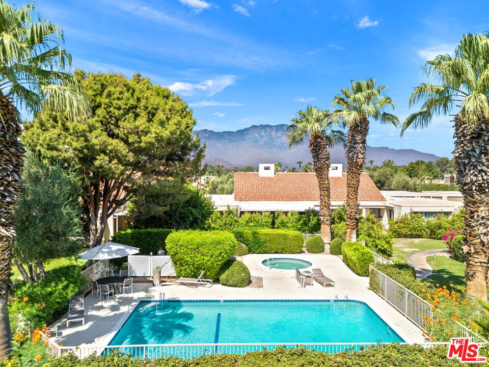 155 Desert W Drive Rancho Mirage, CA 92270 - Photo 47 of 50 a view of a yard with plants and a bench