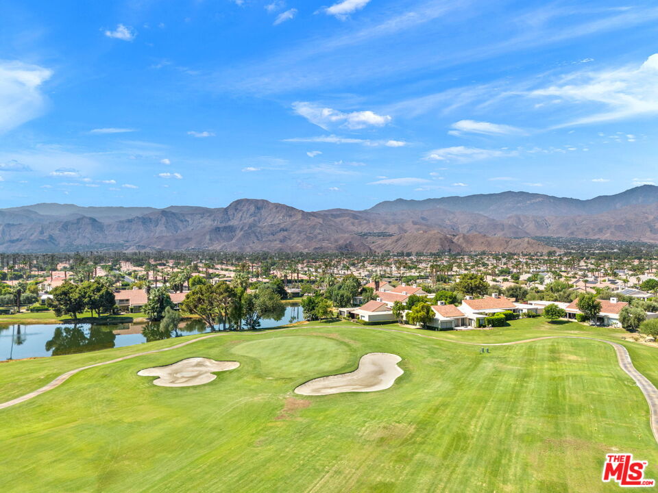 155 Desert W Drive Rancho Mirage, CA 92270 - Photo 49 of 50 a view of a lush green hillside and a houses