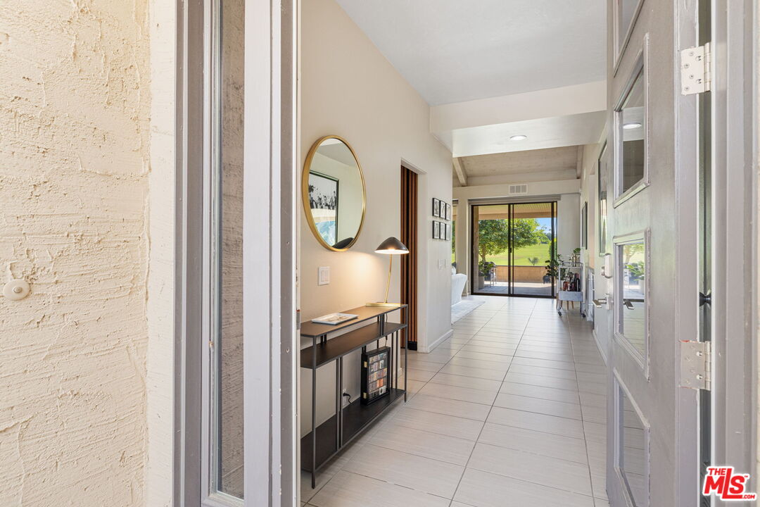 155 Desert W Drive Rancho Mirage, CA 92270 - Photo 7 of 50 a view of a hallway to a livingroom with furniture