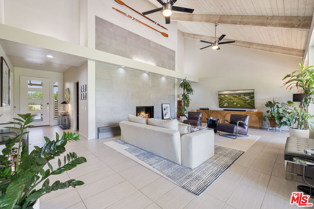 155 Desert W Drive Rancho Mirage, CA 92270 - Photo 9 of 50 a living room with furniture and a potted plant