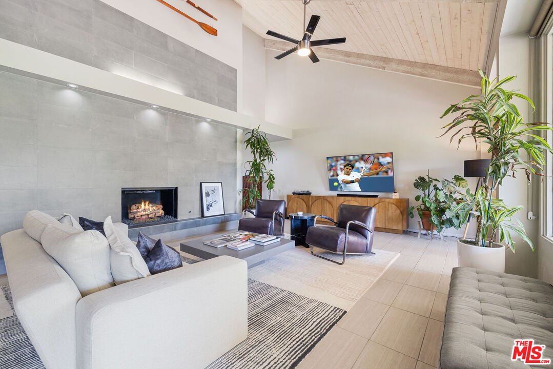 155 Desert W Drive Rancho Mirage, CA 92270 - Photo 10 of 50 a living room with furniture and a potted plant