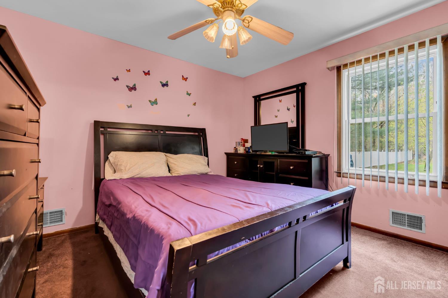 120 Cedar Swamp Road Jackson, NJ 08527 - Photo 12 of 39 a bedroom with a bed and a chandelier