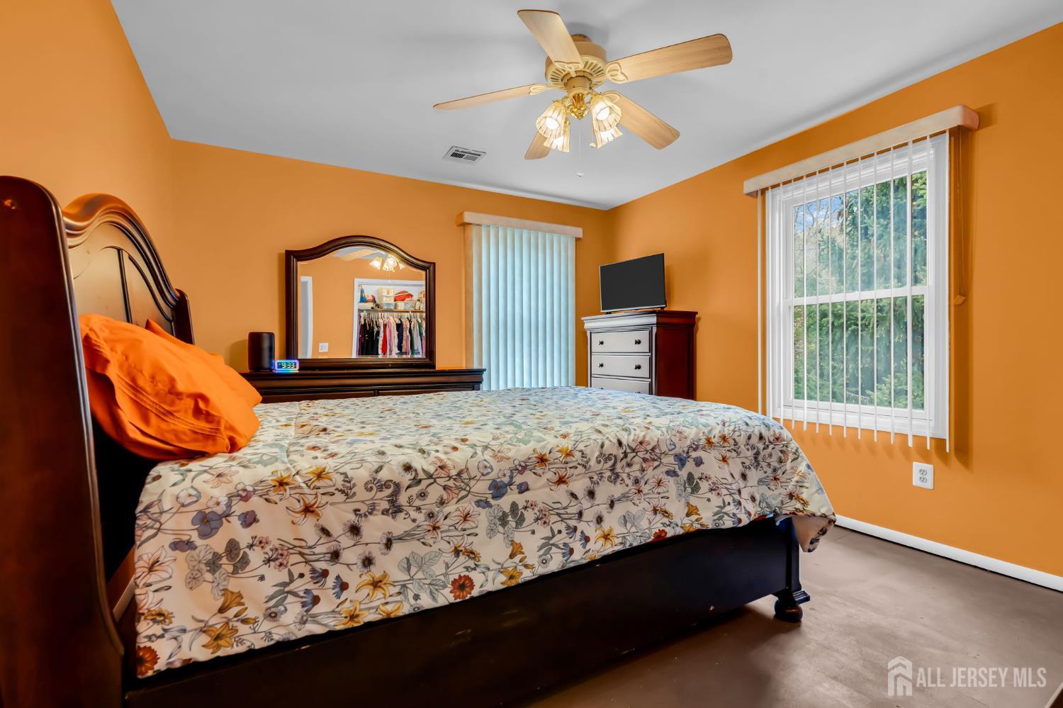 120 Cedar Swamp Road Jackson, NJ 08527 - Photo 15 of 39 a bed sitting in a bedroom next to a window