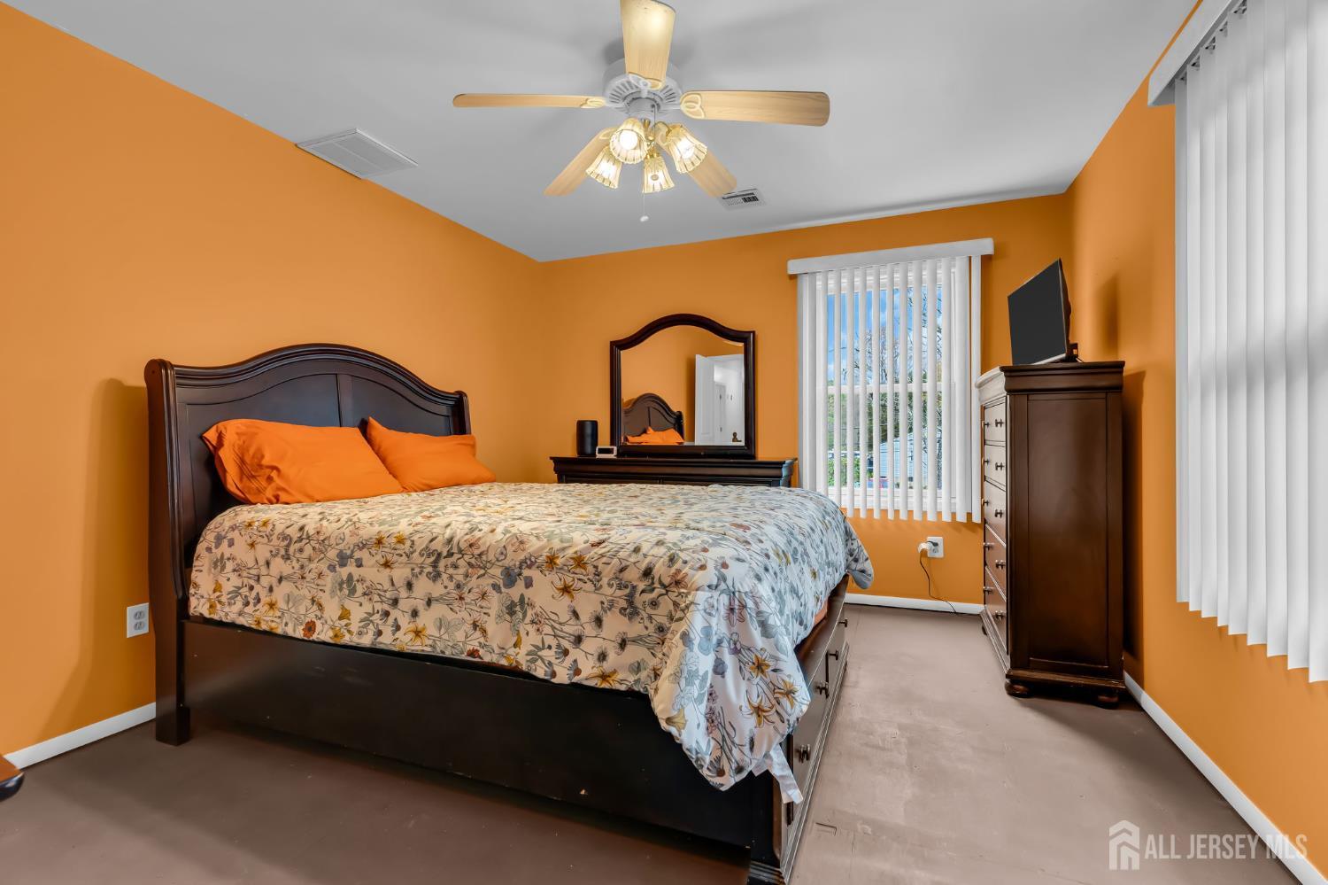 120 Cedar Swamp Road Jackson, NJ 08527 - Photo 16 of 39 a bedroom with a bed and a chandelier