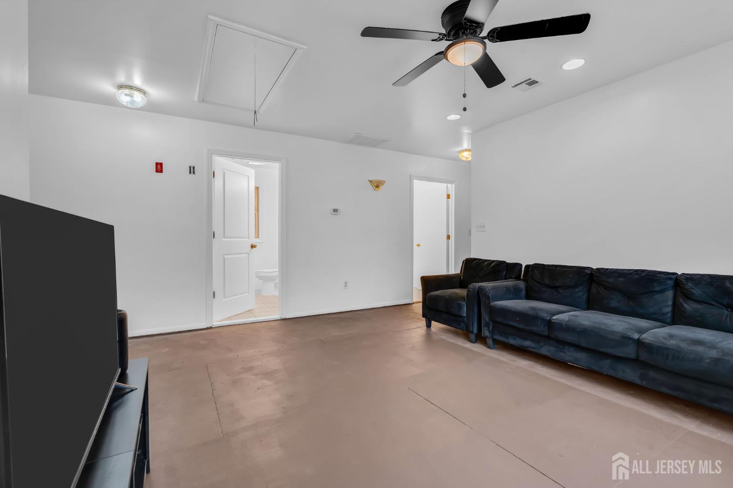 120 Cedar Swamp Road Jackson, NJ 08527 - Photo 20 of 39 a living room with furniture and a ceiling fan
