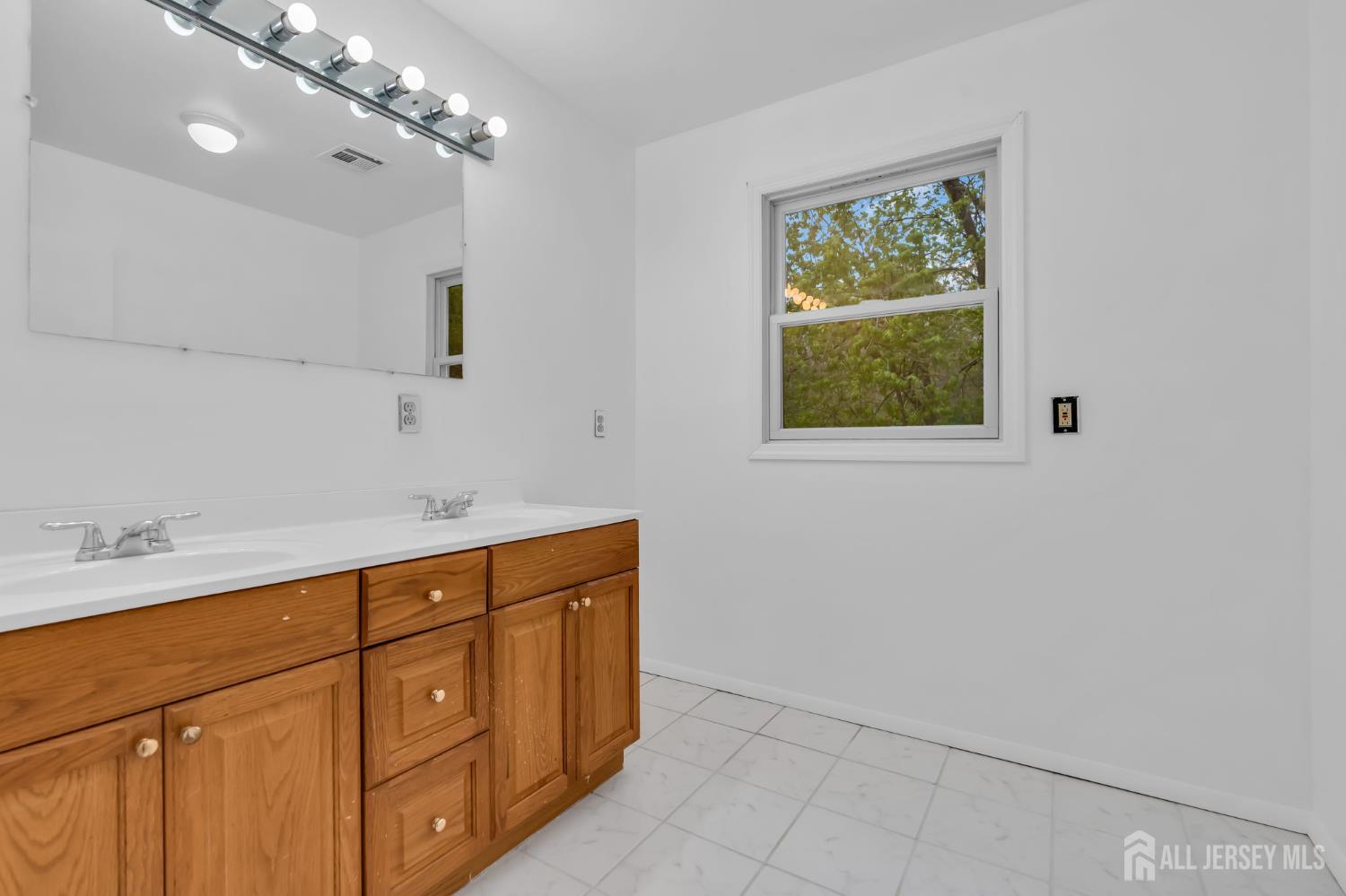 120 Cedar Swamp Road Jackson, NJ 08527 - Photo 21 of 39 a bathroom with a sink a vanity and a mirror