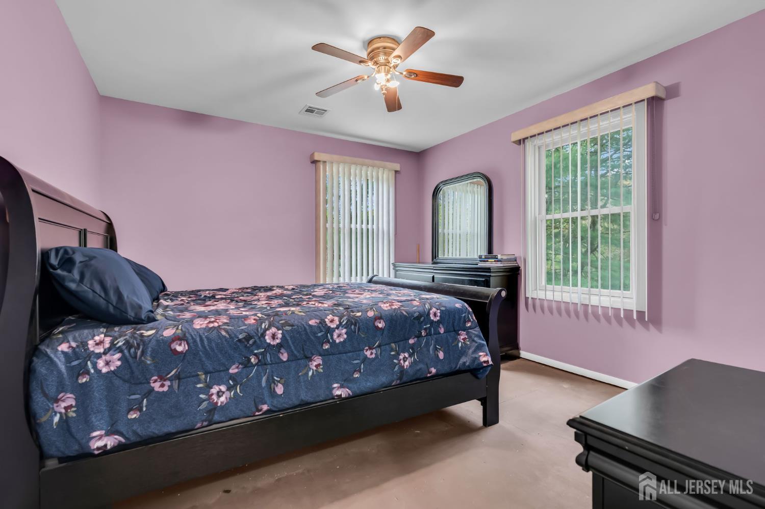 120 Cedar Swamp Road Jackson, NJ 08527 - Photo 22 of 39 a bedroom with a bed and a chandelier