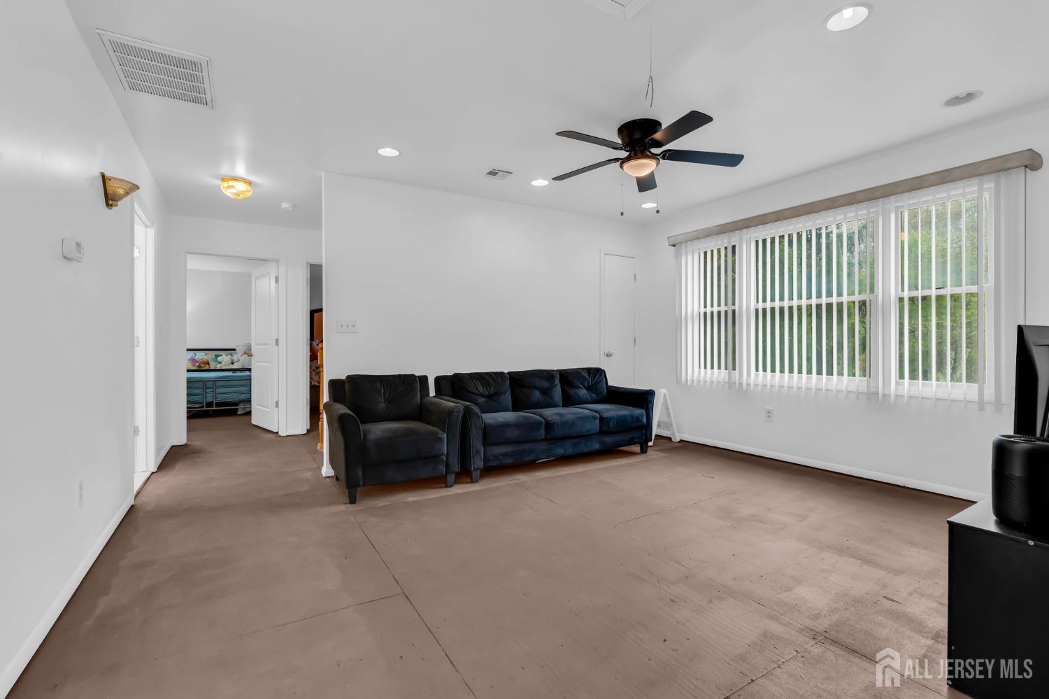 120 Cedar Swamp Road Jackson, NJ 08527 - Photo 23 of 39 a living room with furniture and a ceiling fan