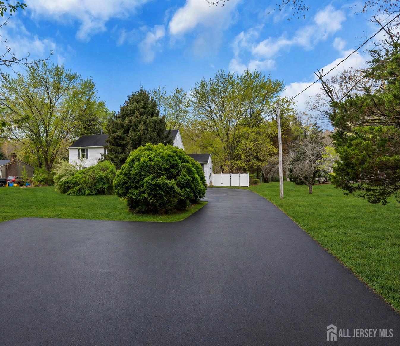 120 Cedar Swamp Road Jackson, NJ 08527 - Photo 4 of 39 a view of a garden with a building in the background