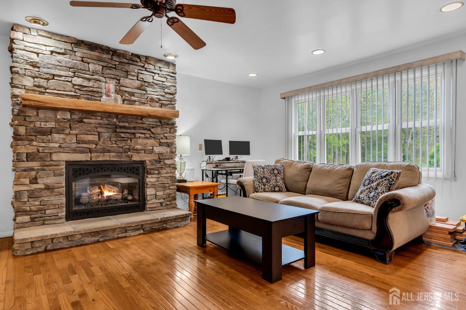 120 Cedar Swamp Road Jackson, NJ 08527 - Photo 5 of 39 a living room with furniture and a fireplace