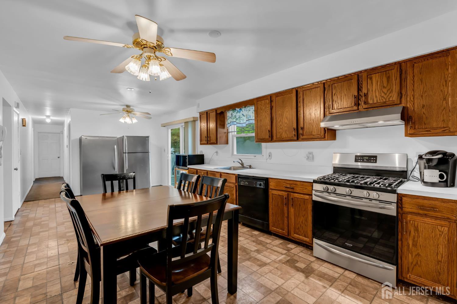 120 Cedar Swamp Road Jackson, NJ 08527 - Photo 7 of 39 a kitchen with a dining table and chairs