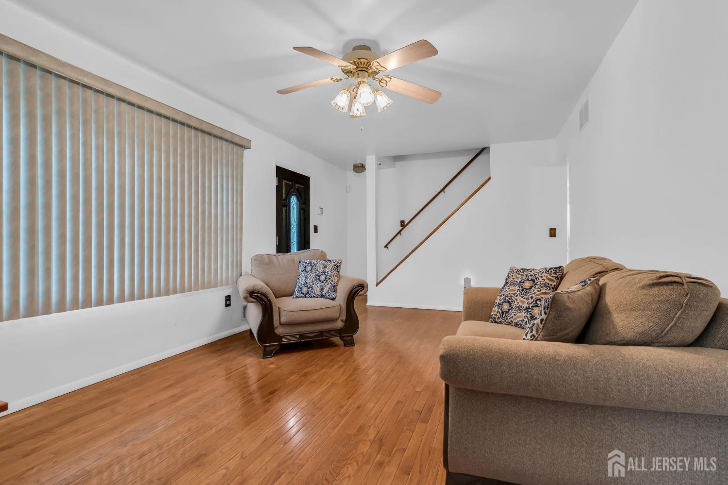 120 Cedar Swamp Road Jackson, NJ 08527 - Photo 9 of 39 a living room with furniture and a chandelier