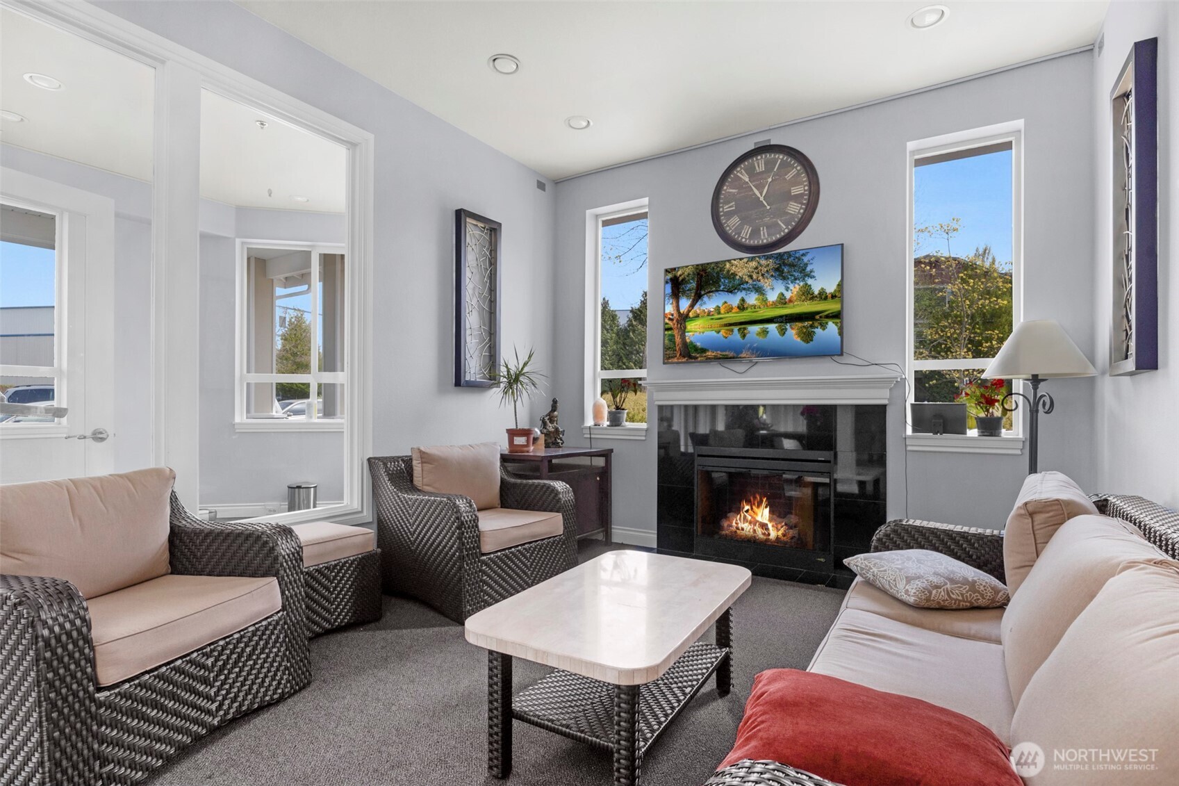 14915 38th Drive Southeast, Unit 3025 Bothell, WA 98012 - Photo 31 of 35 a living room with furniture a clock and a fireplace