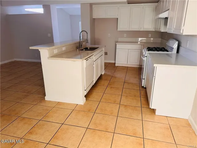 a kitchen with a sink a stove a washer and dryer