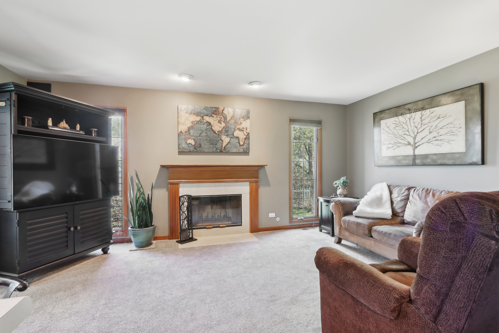 2835 Randall Ridge Court Elgin, IL 60124 - Photo 14 of 39 a living room with furniture a flat screen tv and a fireplace