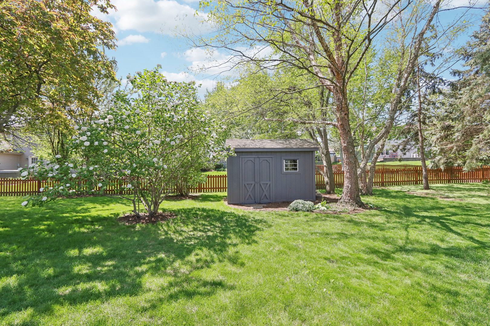 2835 Randall Ridge Court Elgin, IL 60124 - Photo 35 of 39 a backyard of a house with lots of green space and fountain