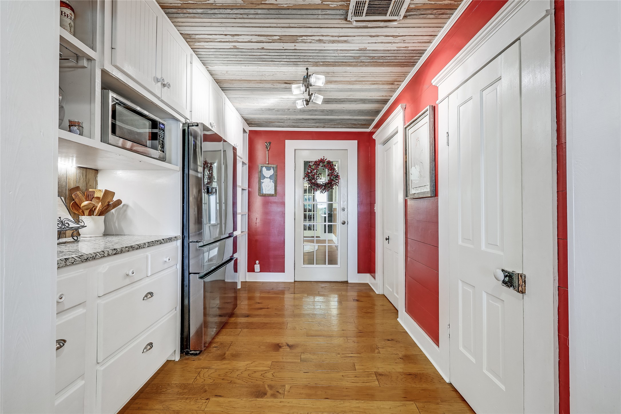 13471 Cedar Valley Road Salado, TX 76571 - Photo 11 of 39 a hallway with windows and chandelier