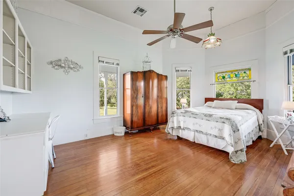 a hallway with windows and chandelier