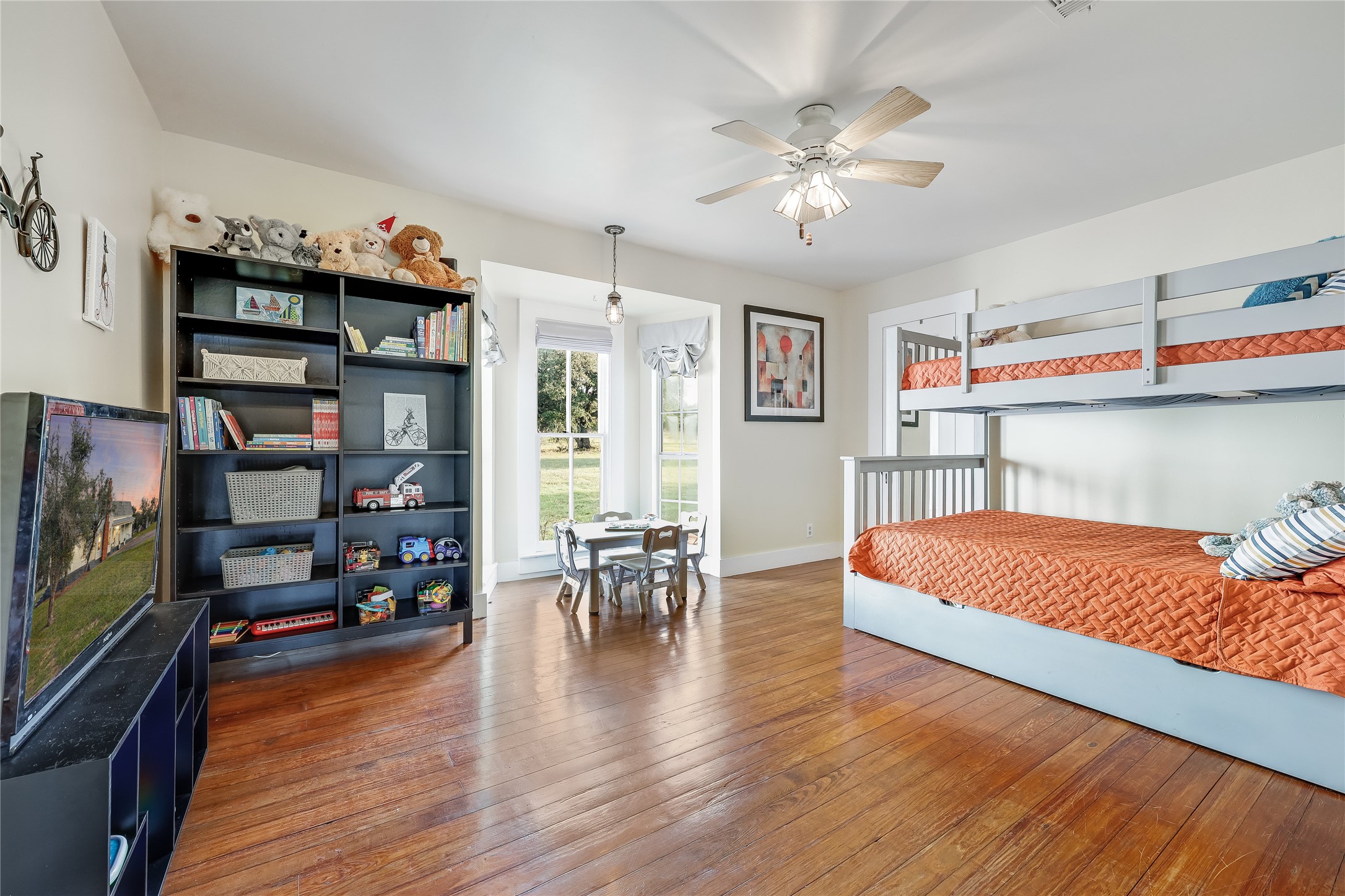 13471 Cedar Valley Road Salado, TX 76571 - Photo 13 of 39 a bedroom with furniture and wooden floor