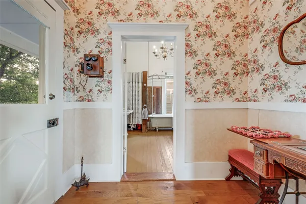 a bedroom with furniture and wooden floor
