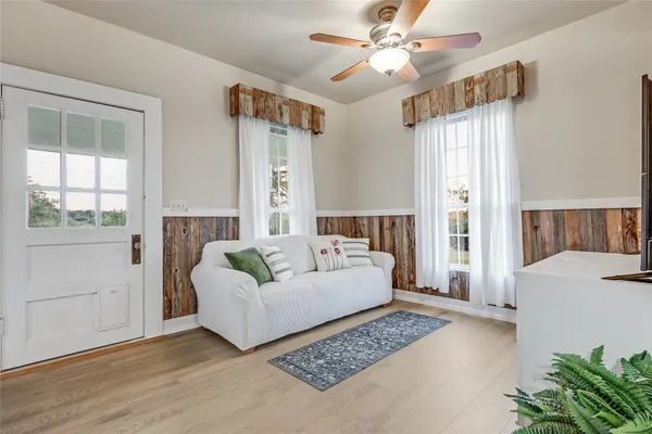 a living room with furniture and wooden floor