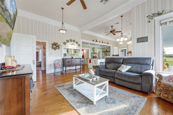 a living room with furniture and kitchen view