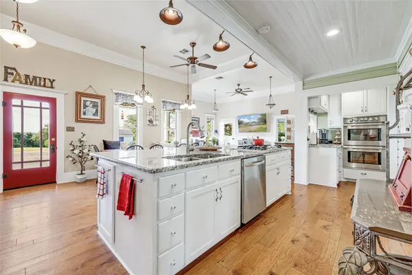 a kitchen with granite countertop counter top space a sink stainless steel appliances and cabinets