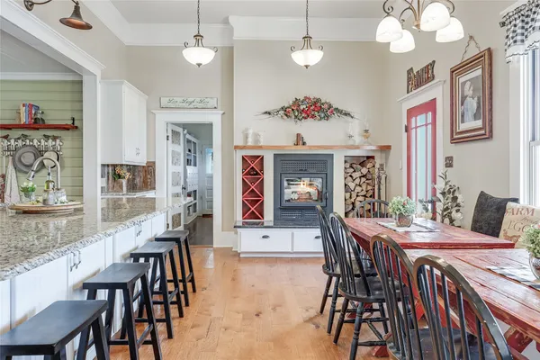 a kitchen with stainless steel appliances kitchen island granite countertop a table and chairs in it