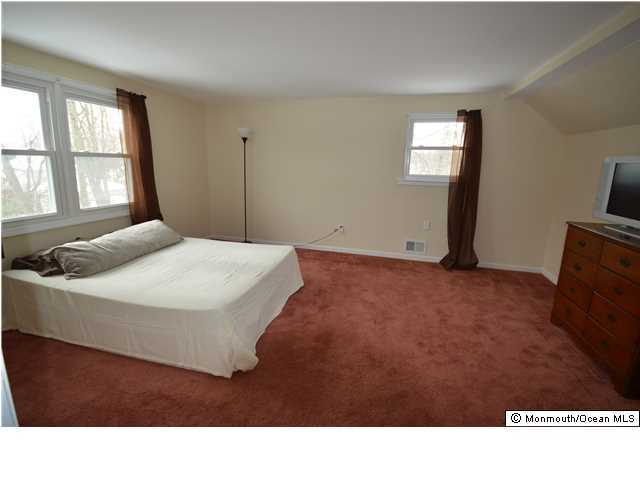 955 Hyson Road Jackson, NJ 08527 - Photo 14 of 15 a living room with a bed furniture and a flat screen tv