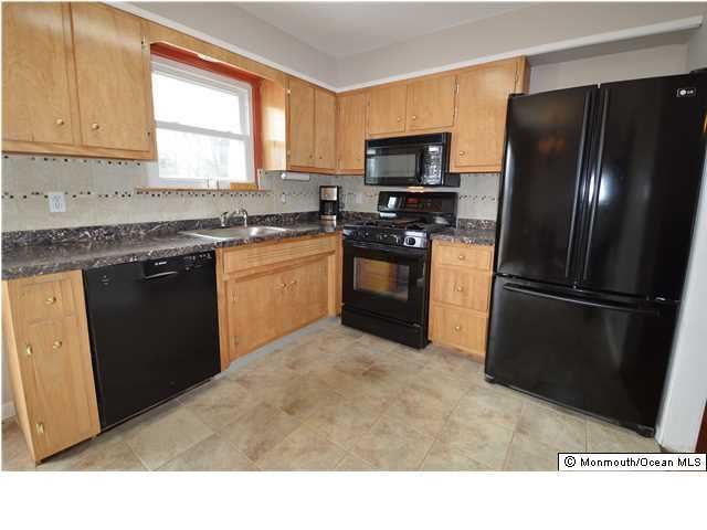 955 Hyson Road Jackson, NJ 08527 - Photo 7 of 15 a kitchen with a refrigerator stove and microwave