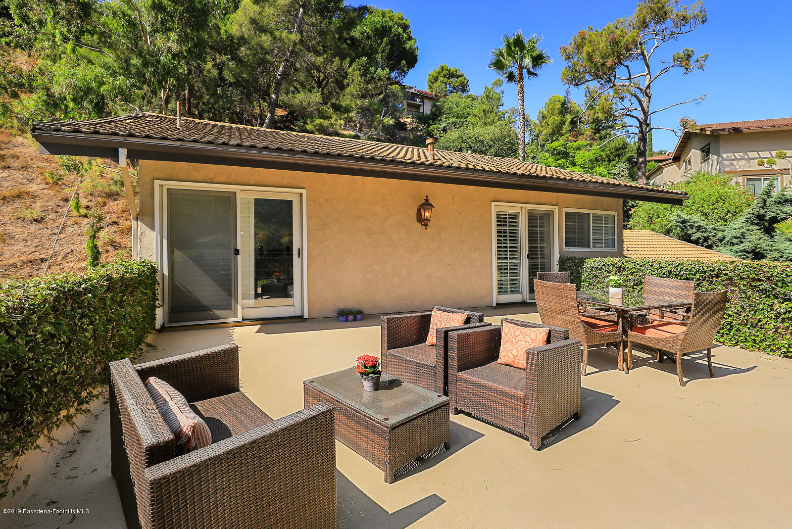 1412 Hillside Drive Glendale, CA 91208 - Photo 27 of 33 a view of a patio with couches table and chairs with wooden fence and potted plants