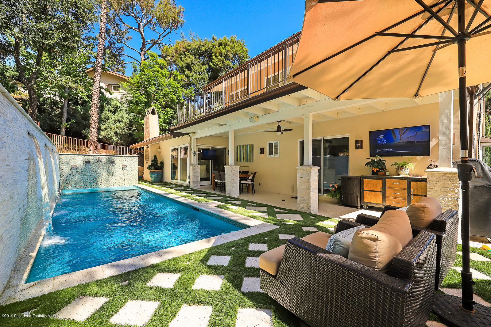 1412 Hillside Drive Glendale, CA 91208 - Photo 29 of 33 a view of a patio with couches chairs under an umbrella with wooden floor