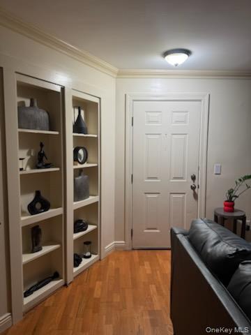 23 Notingham Circle, Unit 23 Peekskill, NY 10566 - Photo 4 of 12 Doorway to outside featuring wood finished floors and ornamental molding