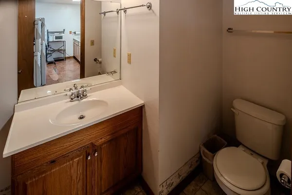 a bathroom with a sink toilet and mirror