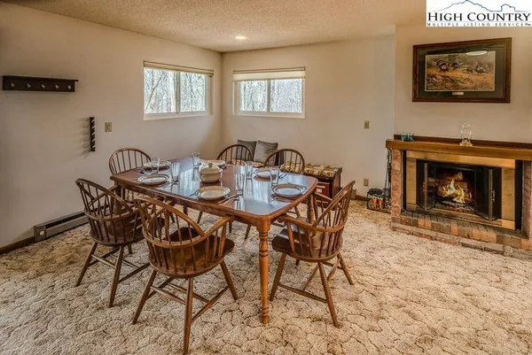 a dining room with furniture and a fireplace
