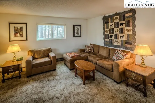 a living room with furniture and a lamp