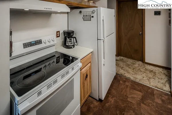 a kitchen with a refrigerator and a stove