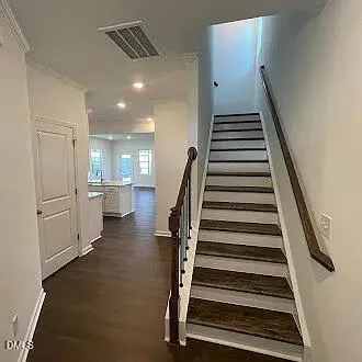 a view of a hallway with entryway and stairs